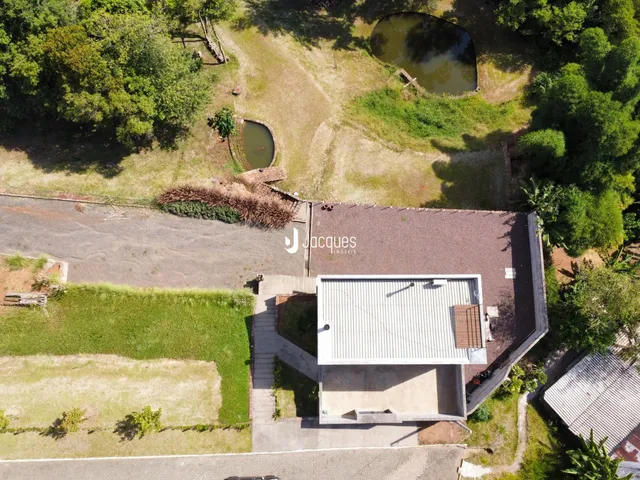 Vista aérea de uma propriedade com área verde e corpo d'água em Lajeado.