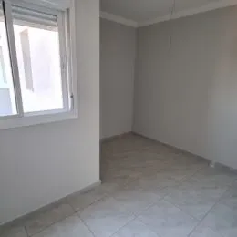 Ambiente interno com paredes brancas e piso de cerâmica.