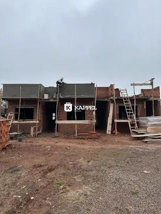 Uma construção residencial em estágio de obra é visível no terreno.