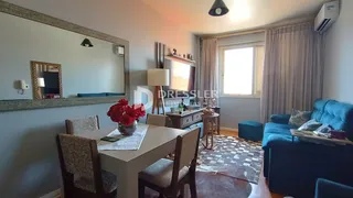 Sala de estar com sofá e mesa de jantar em um apartamento.
