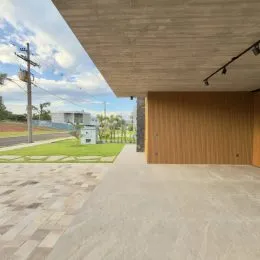 Área externa com piso de concreto e painel de madeira na propriedade.