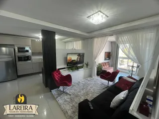 Sala de estar moderna com sofá e decoração clara.