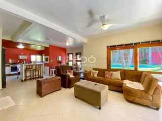Sala de estar com sofá e piso de cerâmica em uma residência.