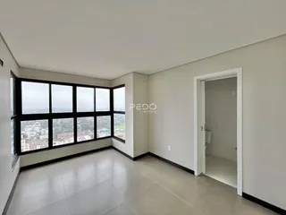 Ambiente interno com grandes janelas que oferecem vista da cidade.