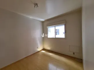 Interior de um ambiente com piso de madeira e janela.