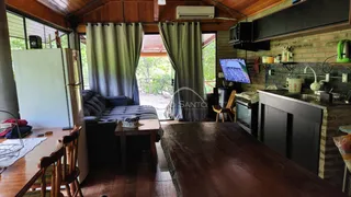 Sala de estar com vista para o jardim externo de uma casa em Lajeado.