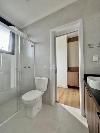 Foto de um banheiro com piso de cerâmica e box de vidro.