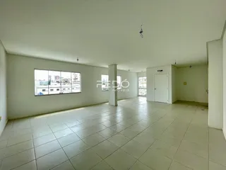 Sala ampla com piso de cerâmica e vista da cidade.