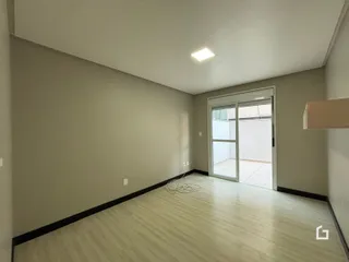 Vista interna de um ambiente com piso de madeira clara.