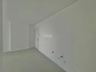 Interior de um cômodo com paredes brancas e piso claro.