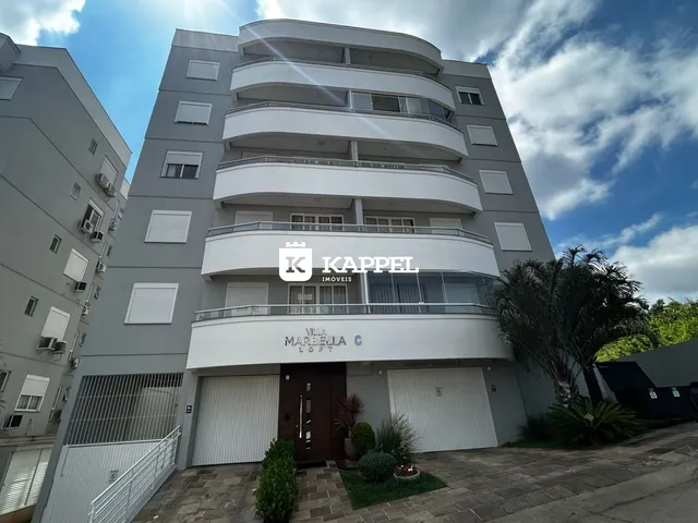 Fachada de um prédio residencial moderno em Lajeado, Brasil, com varandas e garagem no térreo.