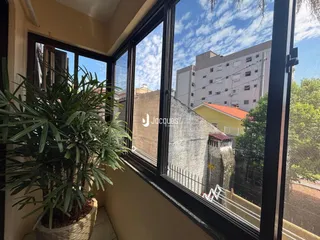 Vista da rua e do prédio de apartamentos em Lajeado, Brasil, através de uma janela.