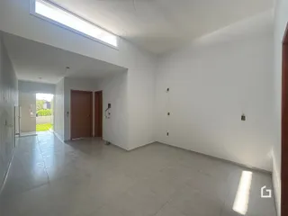 Vista de um corredor interno com paredes brancas e piso de cerâmica.