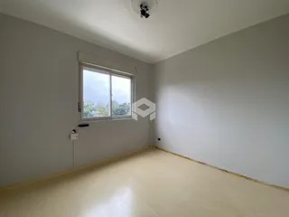 Ambiente interno de uma sala com piso claro e janela.