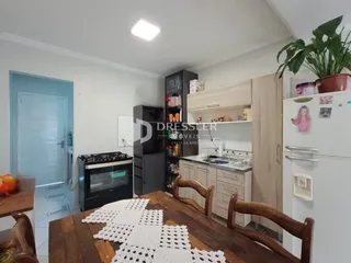 Foto de uma cozinha com móveis de madeira e eletrodomésticos.