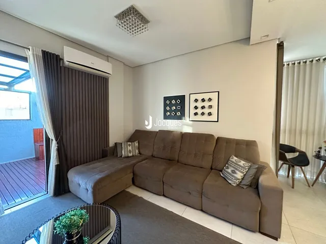 Sala de estar com um sofá grande e janela.