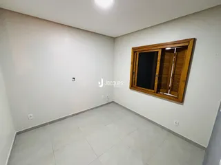Ambiente interno com paredes brancas e piso de cerâmica em uma residência.