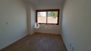 Interior de um cômodo com piso de madeira e janela.