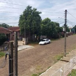 Foto externa mostrando uma área de terra e vegetação em uma propriedade.