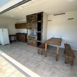 Interior com parede de tijolos aparentes e estantes de madeira em um ambiente interno.