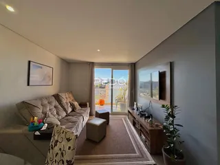 Sala de estar com sofá e decoração moderna em um apartamento.