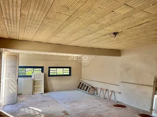 Foto de um ambiente interno em construção com paredes de alvenaria expostas.