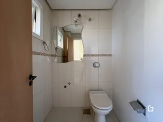 Banheiro com revestimento cerâmico e espelho na parede