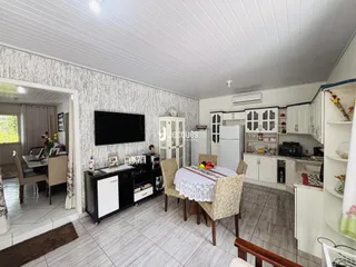 Sala de estar com área de jantar e cozinha em uma residência no Brasil.