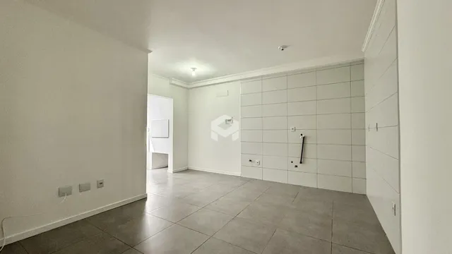 Vista de um corredor interno com piso de cerâmica claro.