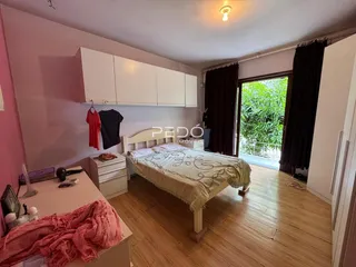Quarto com cama e armário em ambiente claro.
