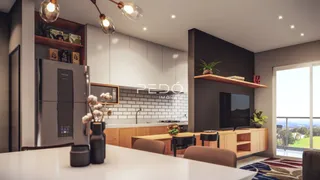 Vista da cozinha moderna com armários de madeira e eletrodomésticos em Lajeado.
