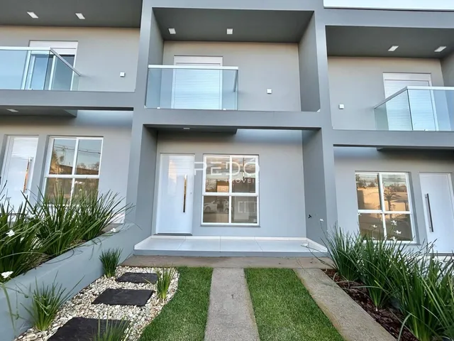 Fachada moderna de um edifício residencial em Lajeado, Brasil, com jardim na frente.