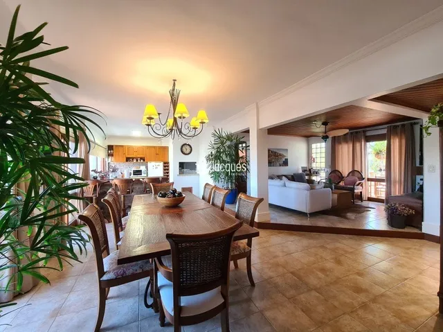 Sala de jantar com mesa de madeira e piso de madeira.