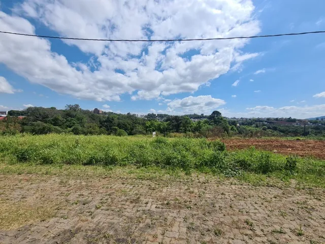 Vista de vegetação e colinas sob um céu parcialmente nublado.