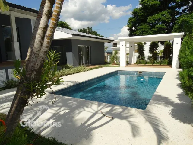 Fachada de casa com piscina no quintal.