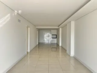 Corredor interno de uma residência com piso de cerâmica clara.