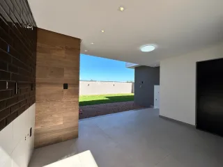 Foto de um corredor interno com parede de madeira e piso claro.