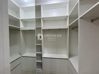 Armários e prateleiras brancas em um ambiente interno.