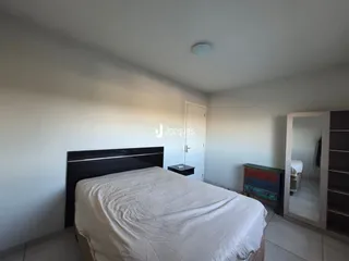Quarto com cama e armário em ambiente claro.