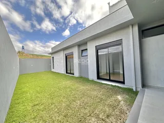 Fachada de uma casa moderna com jardim gramado em Lajeado, Brasil.