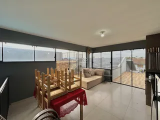 Sala de estar com grandes portas de vidro abrindo para a área externa.
