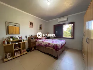 Quarto com cama e armário em um ambiente claro.