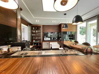 Cozinha moderna com armários de madeira e iluminação pendente.
