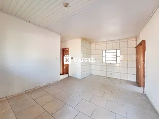 Ambiente interno com piso de cerâmica e paredes brancas em uma residência.