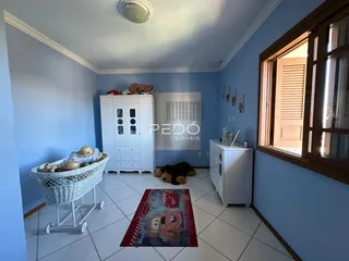 A foto mostra um quarto com paredes azul claro e piso de cerâmica.