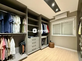 Foto de um quarto com armários e roupas penduradas em um ambiente interno.