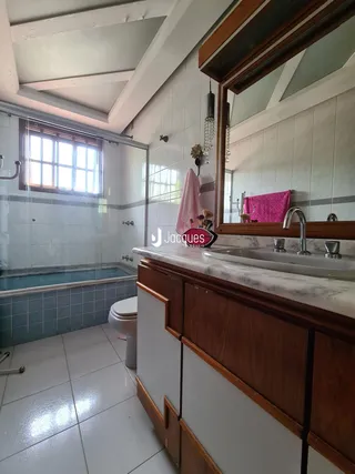 Banheiro com box de vidro e banheira.