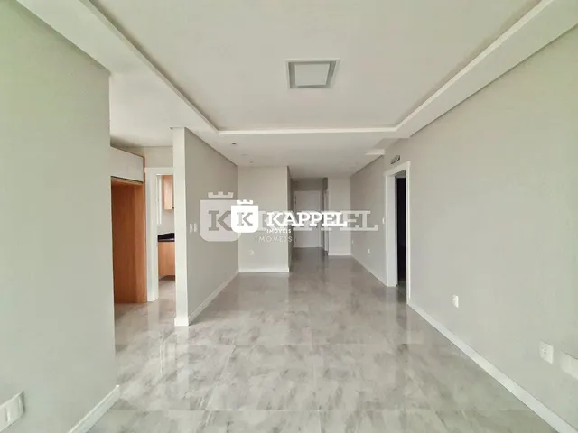 Foto de um corredor interno de uma residência com piso de porcelanato claro.