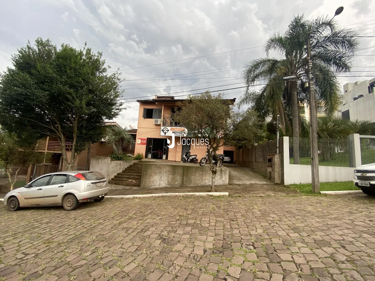 A fachada de uma residência em Lajeado, Brasil, com jardim e estacionamento.