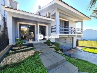 Fachada moderna de uma residência em Lajeado, Brasil, com escadaria e varanda.